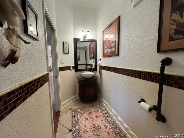 a spacious bathroom with a granite countertop sink a toilet a mirror and shower
