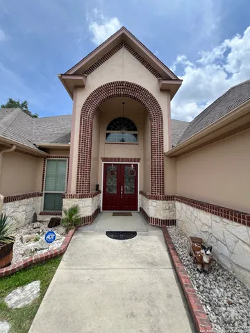 a dining area with furniture and chandelier