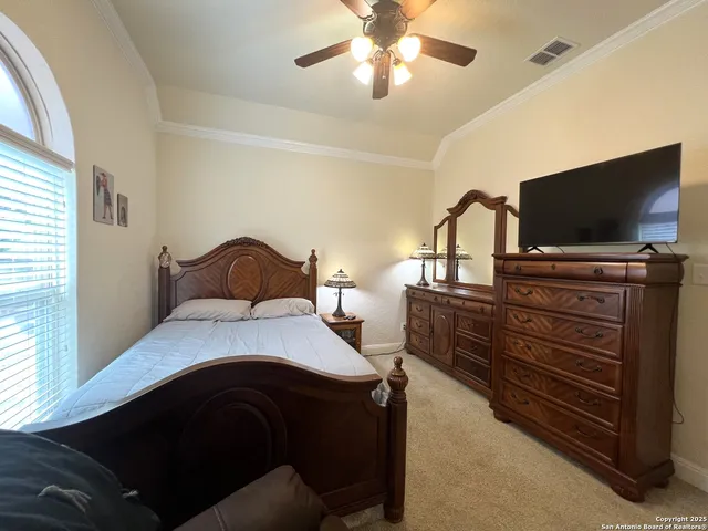 a living room with furniture a rug and white walls
