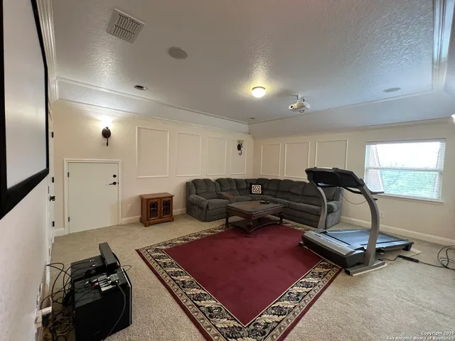 a view of a house with a yard and sitting area