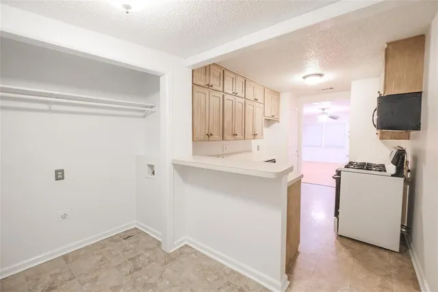 a kitchen with a refrigerator and a stove top oven