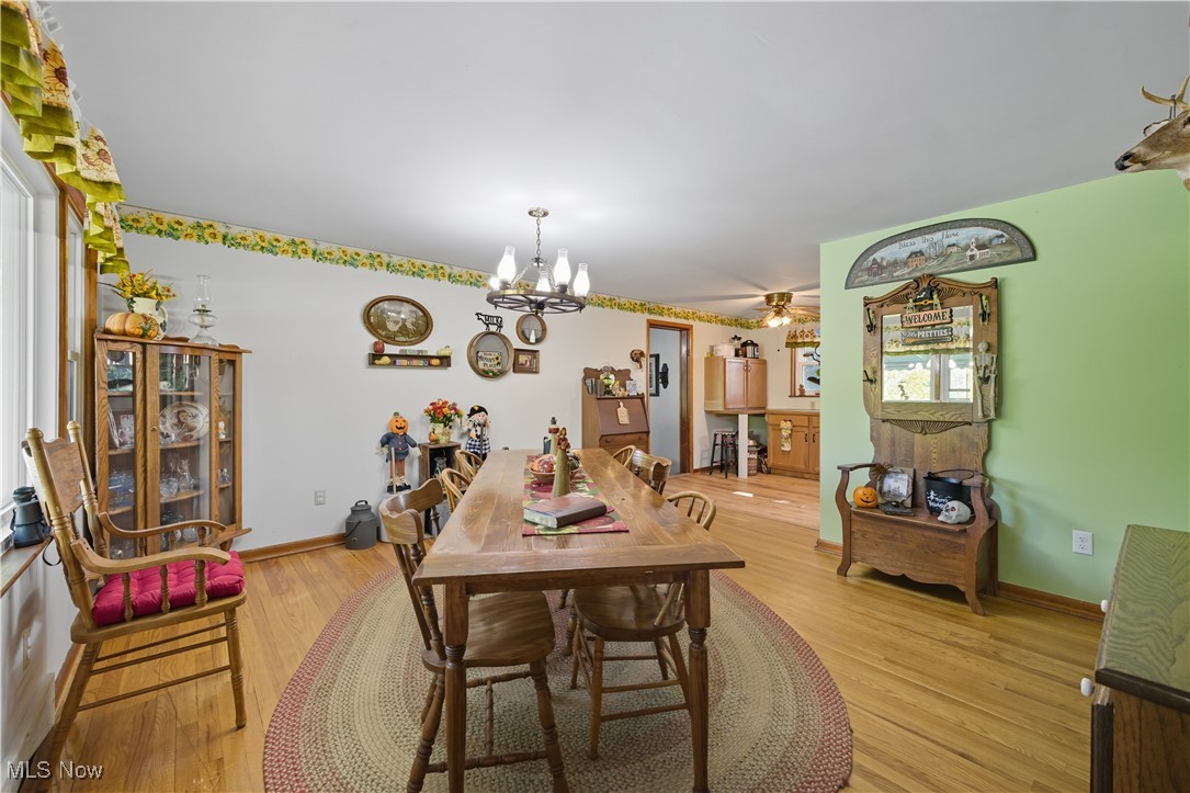 31085 Georgetown Road Salem, OH 44460 - Photo 8 of 50 Dining area with light wood-style flooring, a ceiling fan, and a chandelier