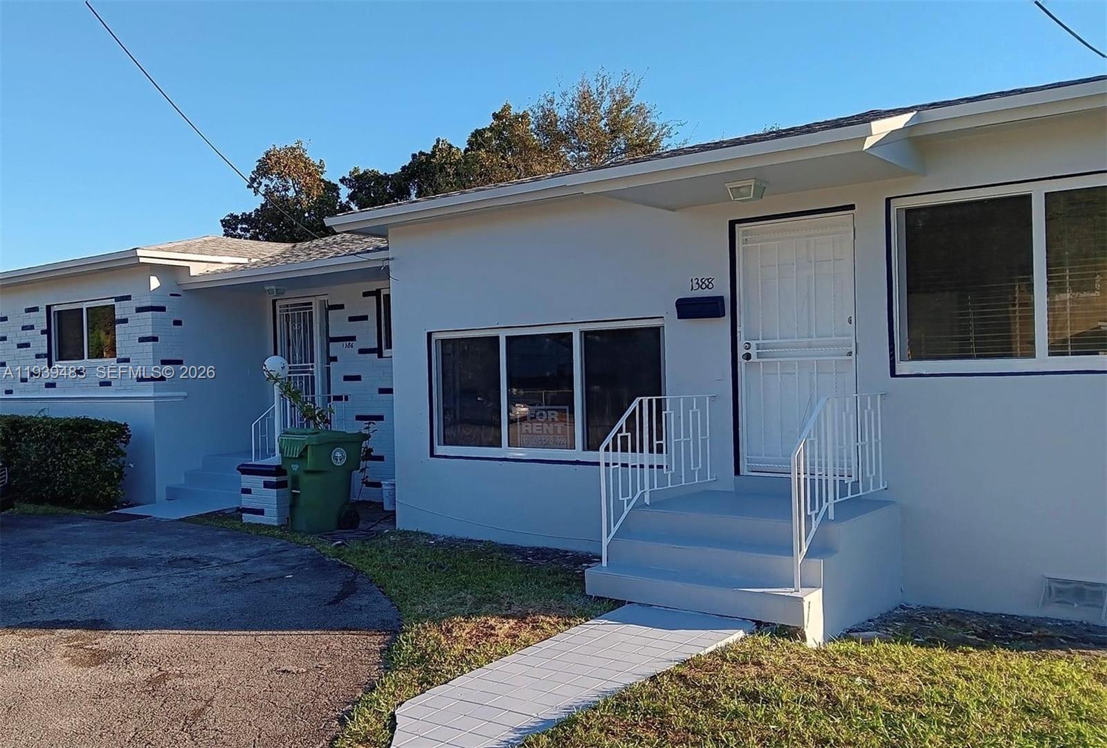 1386 Northwest 38th Street, Unit 1 Miami, FL 33142 - Photo 1 of 6 a front view of a house with garden