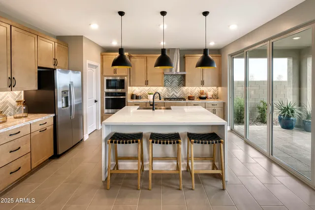 a kitchen with kitchen island a sink dining table and chairs