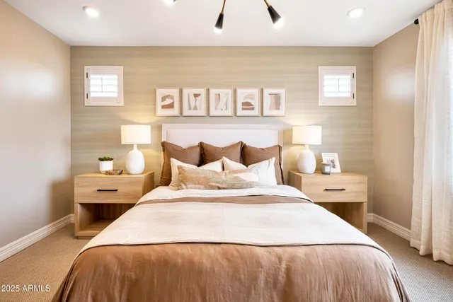 a bedroom with a bed and painting on the wall