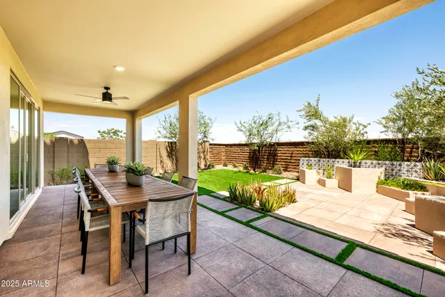 a view of a patio with a table chairs and a backyard