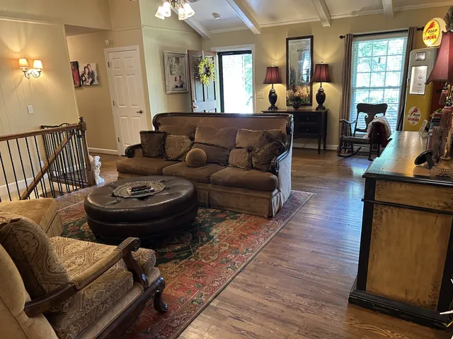 a living room with furniture a fireplace and a flat screen tv