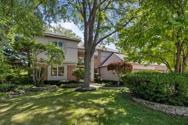 a view of a house with a tree in a yard