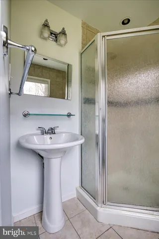 a bathroom with a sink a mirror and shower