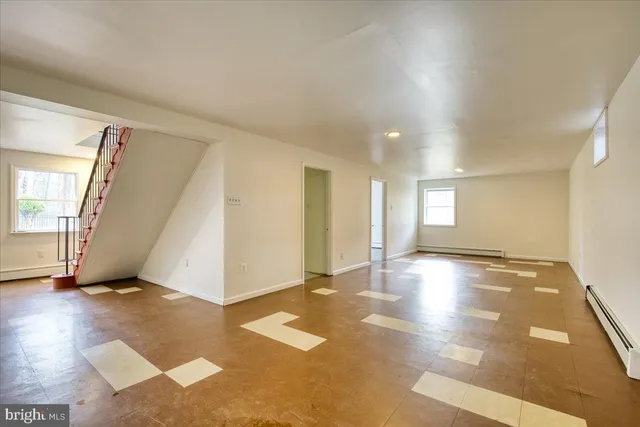 an empty room with windows and entrance