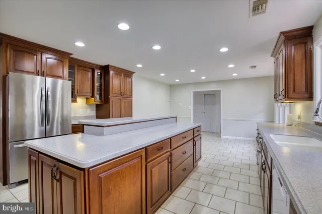a kitchen with stainless steel appliances granite countertop a sink a stove and a refrigerator