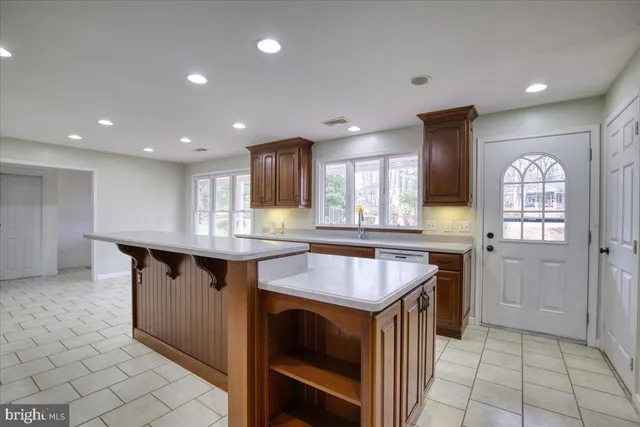 a kitchen with granite countertop a sink and a stove