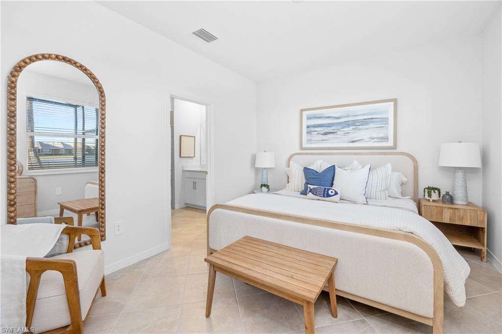 14888 Anchorage Road Punta Gorda, FL 33982 - Photo 17 of 34 Bedroom with light tile patterned floors and ensuite bath