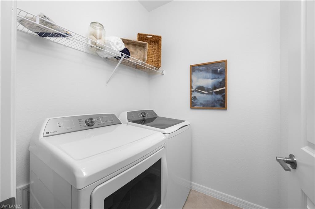 14888 Anchorage Road Punta Gorda, FL 33982 - Photo 20 of 34 Washroom featuring washer and clothes dryer and baseboards
