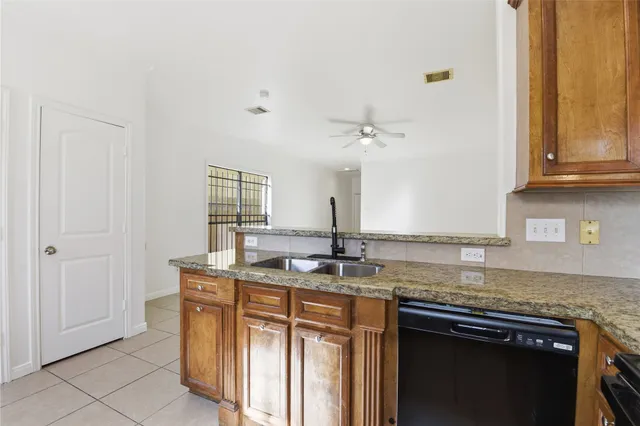 a kitchen with stainless steel appliances granite countertop a sink and a cabinets