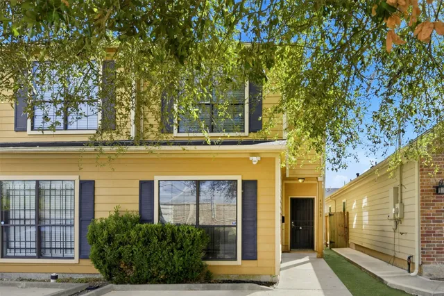 a view of a brick house with large windows