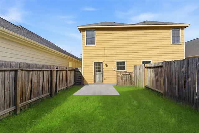 a view of a backyard with wooden fence