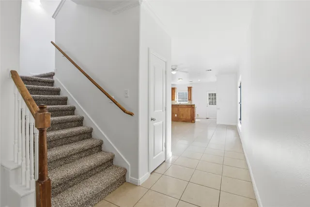 a view of a hallway with wooden floor and staircase