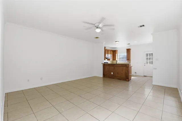 a view of a kitchen with cabinet a ceiling fan and a rug