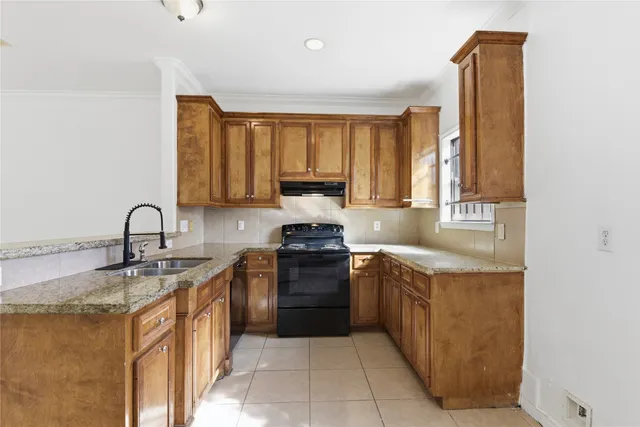 a kitchen with a sink stove and cabinets