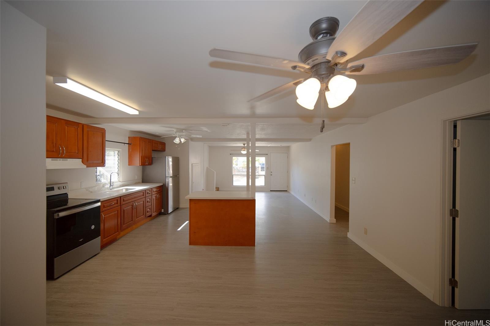 a large kitchen with stainless steel appliances granite countertop a lot of counter space and a sink
