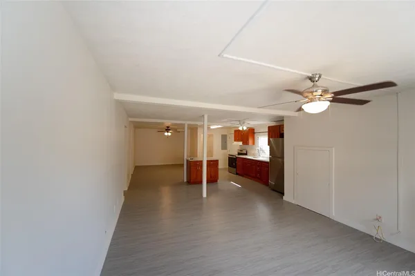 a view of a livingroom with wooden floor and a ceiling fan