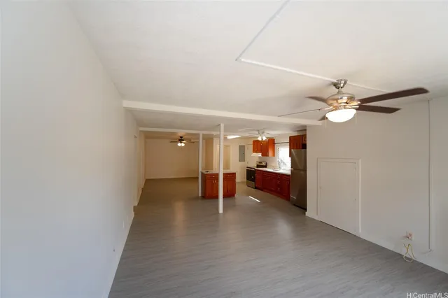 a view of a livingroom with wooden floor and a ceiling fan