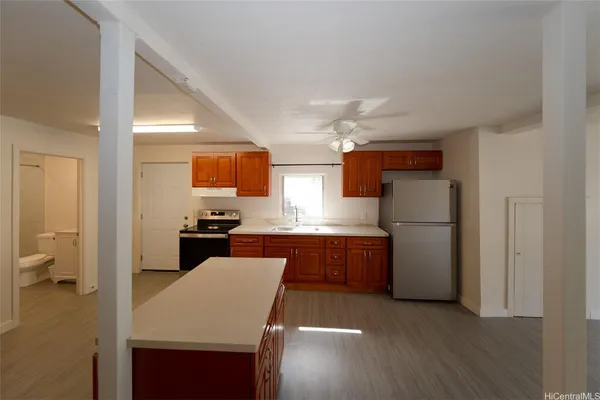 a kitchen with a refrigerator a sink dishwasher with a dining table and chairs