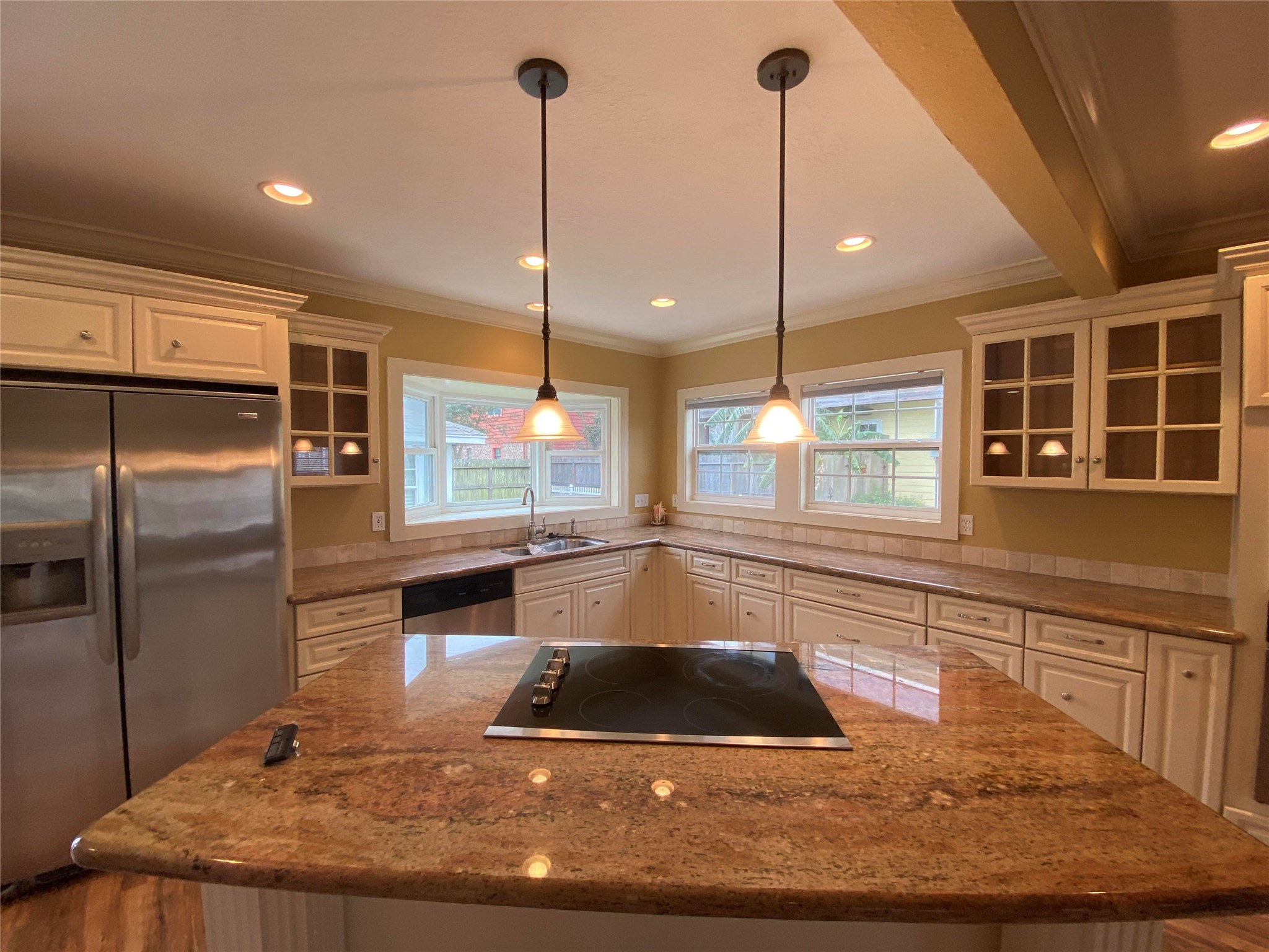 911 Hawthorne Road Clear Lake Shores, TX 77565 - Photo 12 of 50 Gorgeous Island Cooktop with Custom Granite and Pendant Lighting In This Sunny Kitchen