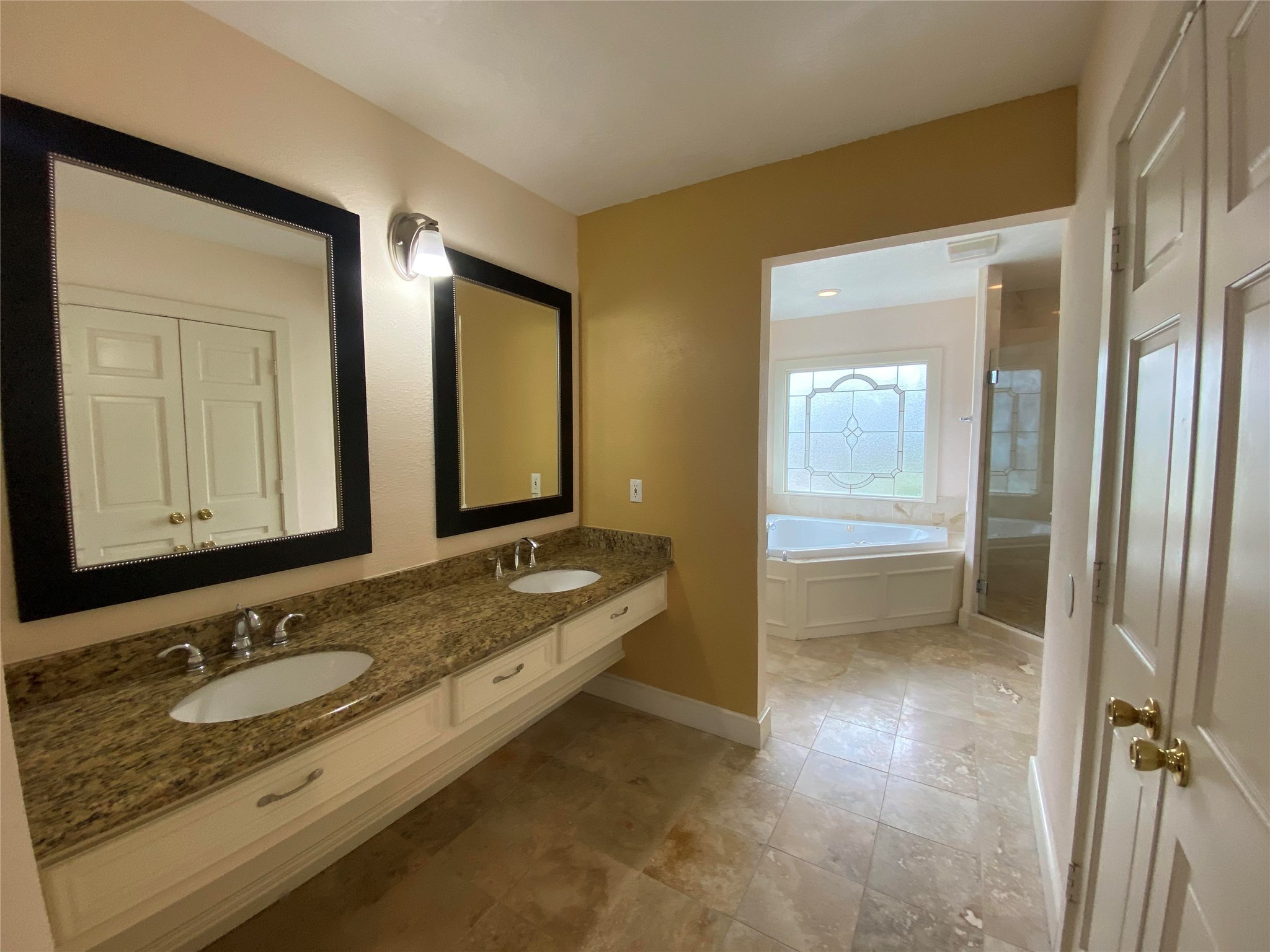 911 Hawthorne Road Clear Lake Shores, TX 77565 - Photo 18 of 50 Master Bathroom With Double Sinks, Vanity Space, Granite Countertops And Travertine Flooring