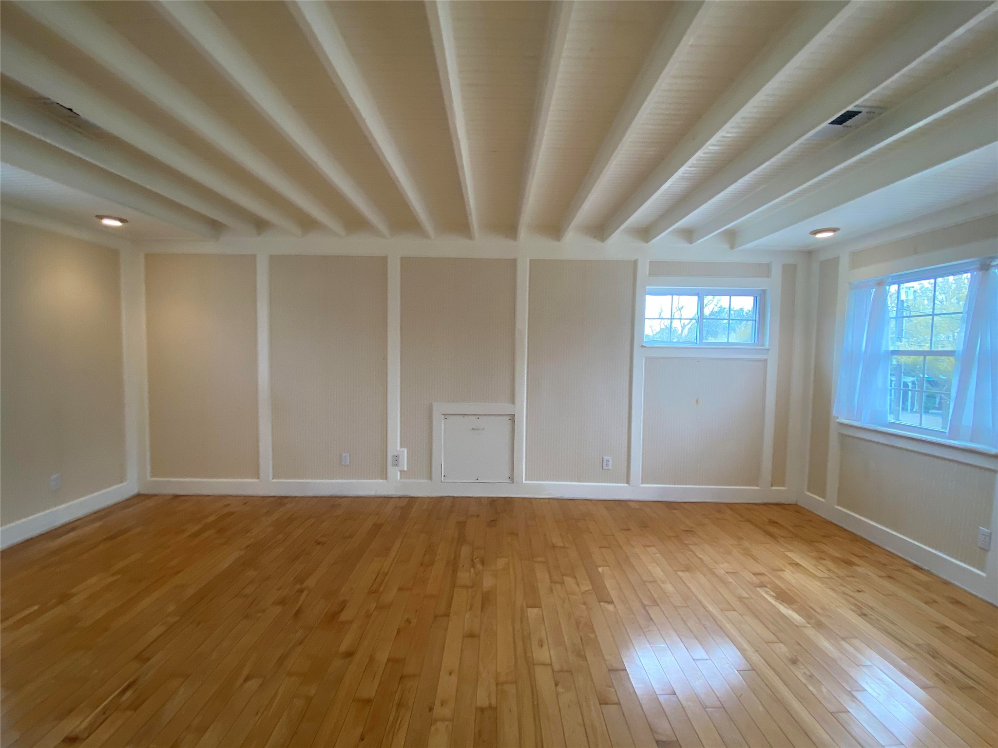 911 Hawthorne Road Clear Lake Shores, TX 77565 - Photo 26 of 50 HUGE Second Master Bedroom On The 2nd Floor Boasts Wood Floors, White Beam Ceilings, Lots Of Windows And Tons Of Molding.
