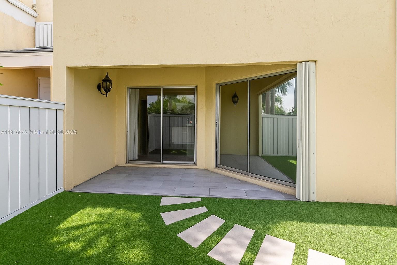 6820 Southwest 45th Lane, Unit 140 Miami, FL 33155 - Photo 2 of 18 a view of backyard with porch