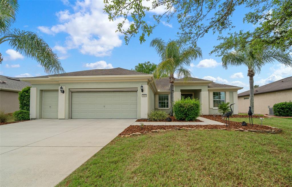 9809 Southwest 63rd Loop Ocala, FL 34481 - Photo 1 of 1 a front view of a house with garden
