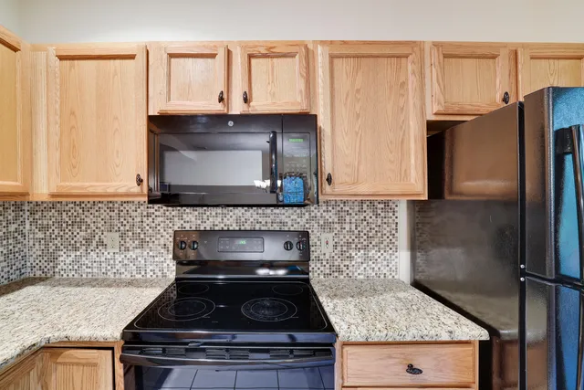 a stove top oven sitting inside of a kitchen