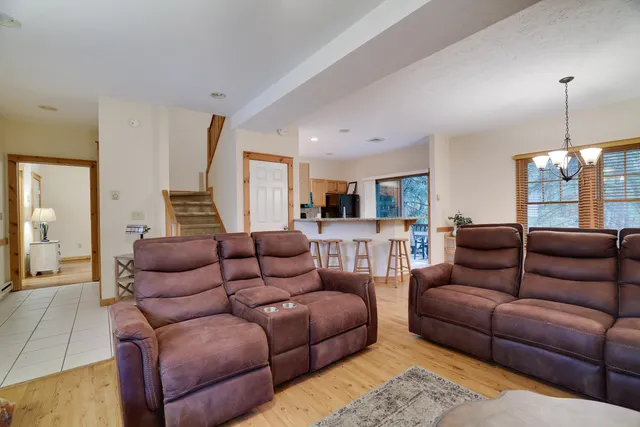 a living room with furniture ceiling fan and a rug