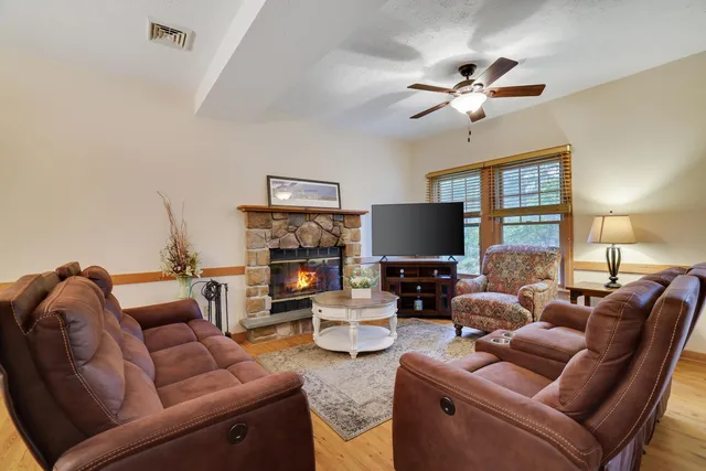 a living room with furniture a fireplace and a flat screen tv