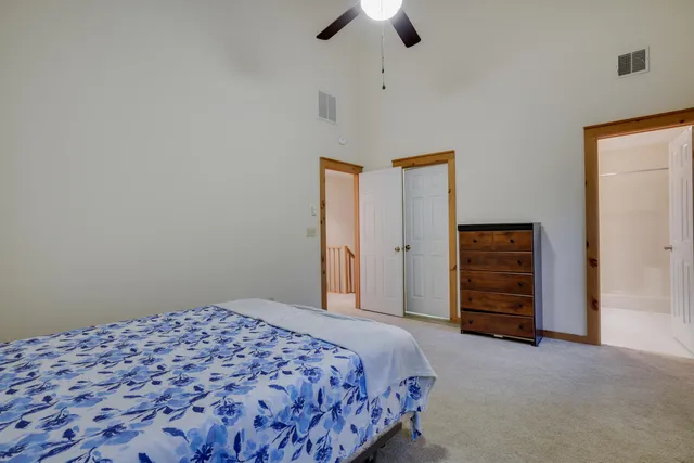 a bedroom with a bed and a dresser