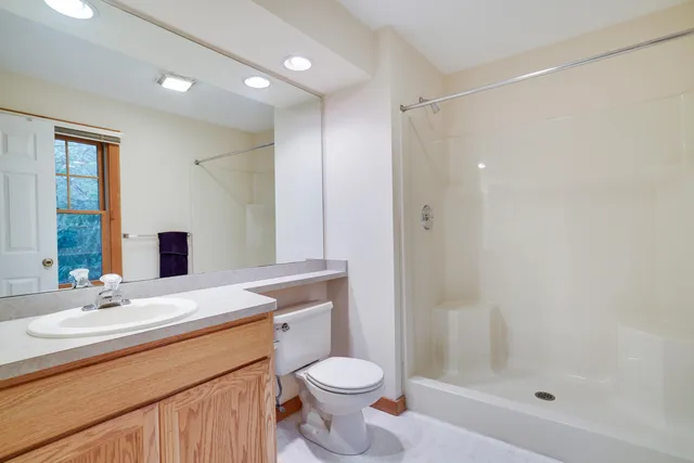 a bathroom with a sink toilet and shower