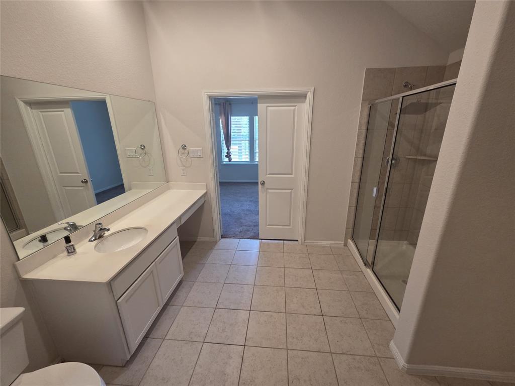 1512 Springtree Drive McKinney, TX 75071 - Photo 12 of 23 a bathroom with a sink a mirror and a toilet