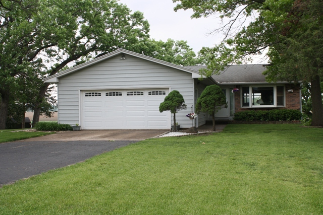 860 Riverside Drive Dixon, IL 61021 - Photo 1 of 13 a view of a house with a yard and potted plants