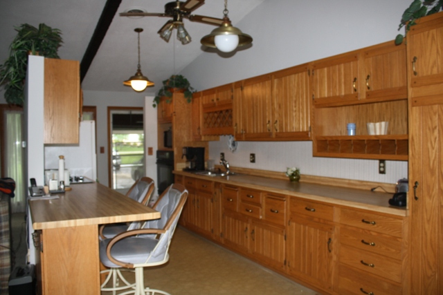 860 Riverside Drive Dixon, IL 61021 - Photo 3 of 13 a kitchen with stainless steel appliances a table chairs sink and cabinets
