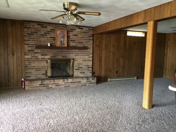 860 Riverside Drive Dixon, IL 61021 - Photo 9 of 13 a view of an empty room with a fireplace and a fan