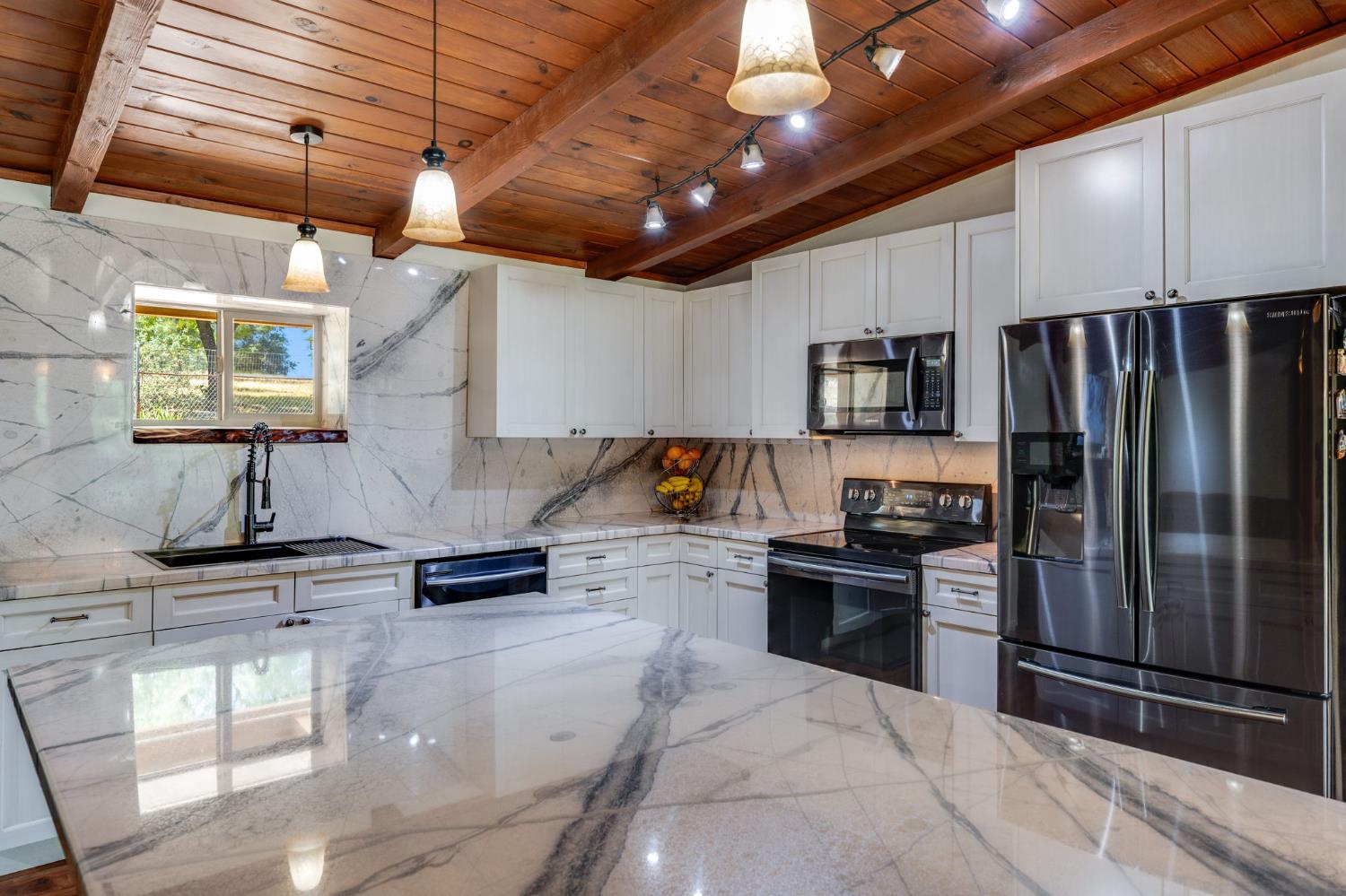 4600 El Caminito Road Shingle Springs, CA 95682 - Photo 14 of 76 a kitchen with granite countertop stainless steel appliances and wooden cabinets