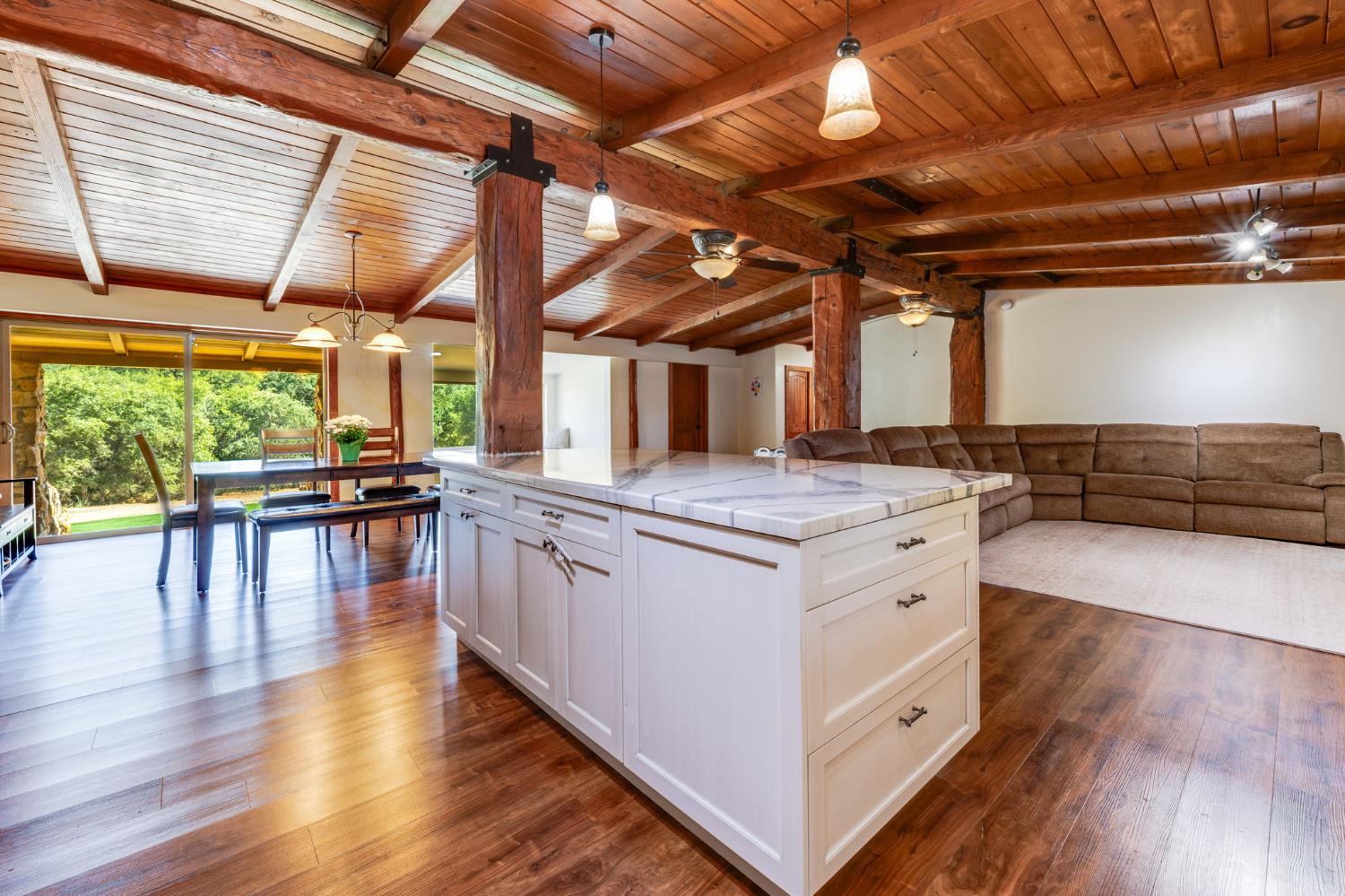 4600 El Caminito Road Shingle Springs, CA 95682 - Photo 15 of 76 a kitchen with stainless steel appliances granite countertop wooden floors and white walls