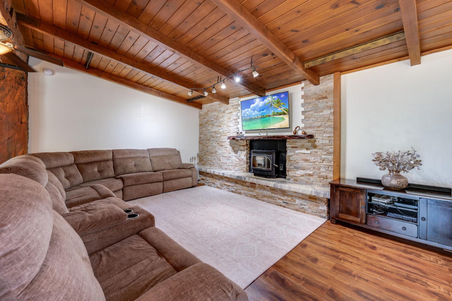 4600 El Caminito Road Shingle Springs, CA 95682 - Photo 18 of 76 a living room with furniture a fireplace and a flat screen tv