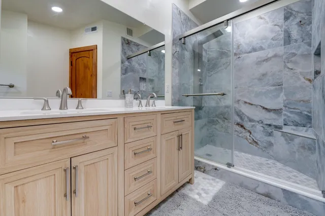 a kitchen with a refrigerator a stove a sink and a oven with wooden floor