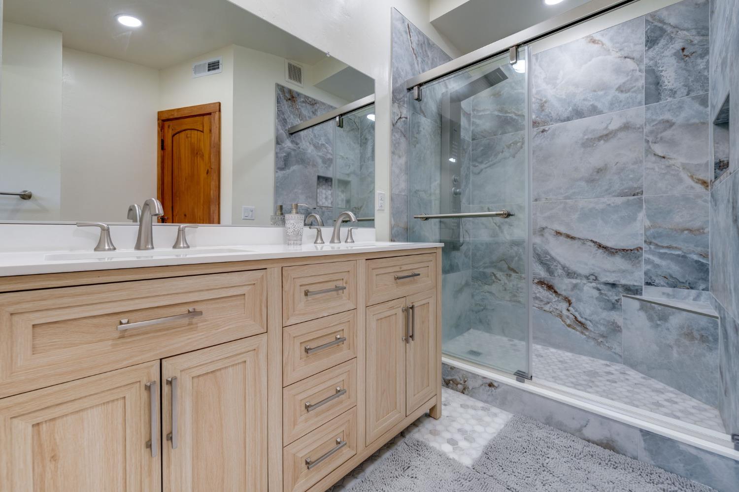 4600 El Caminito Road Shingle Springs, CA 95682 - Photo 27 of 76 a bathroom with a double vanity sink mirror and shower