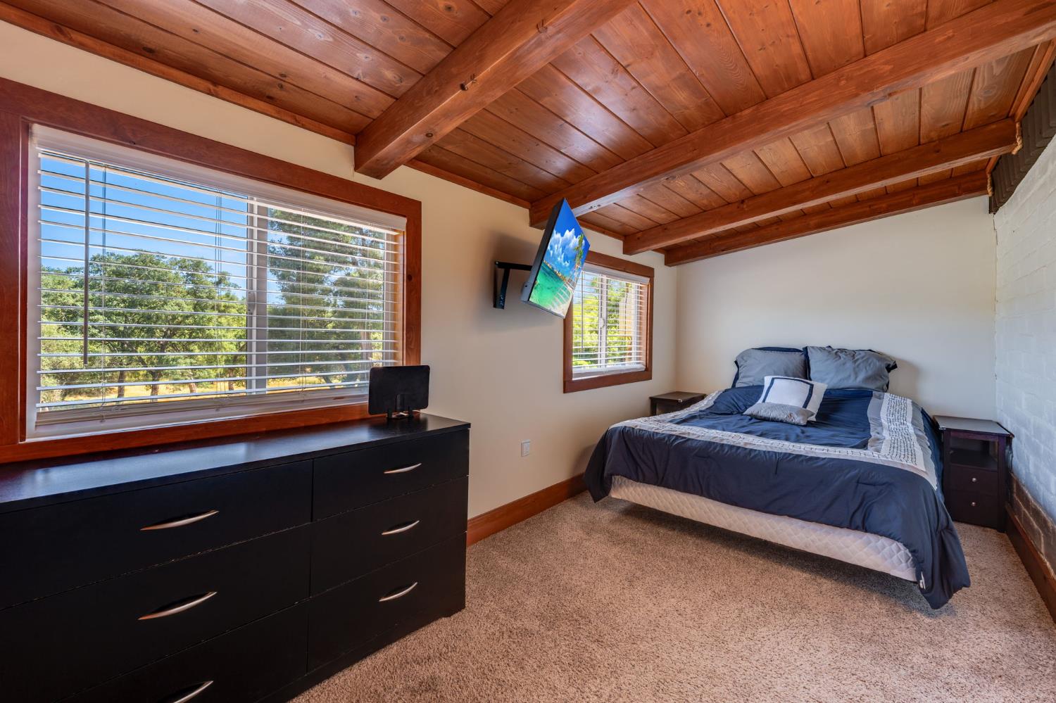 4600 El Caminito Road Shingle Springs, CA 95682 - Photo 30 of 76 a spacious bedroom with a bed and a window