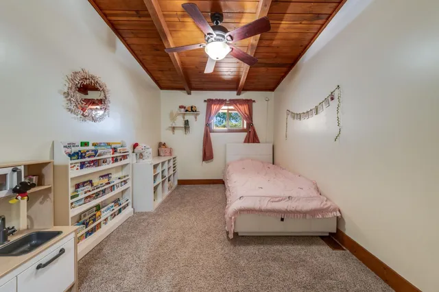 a bedroom with a bed and a table