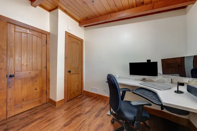 a spacious bedroom with a bed a couch and dresser in it